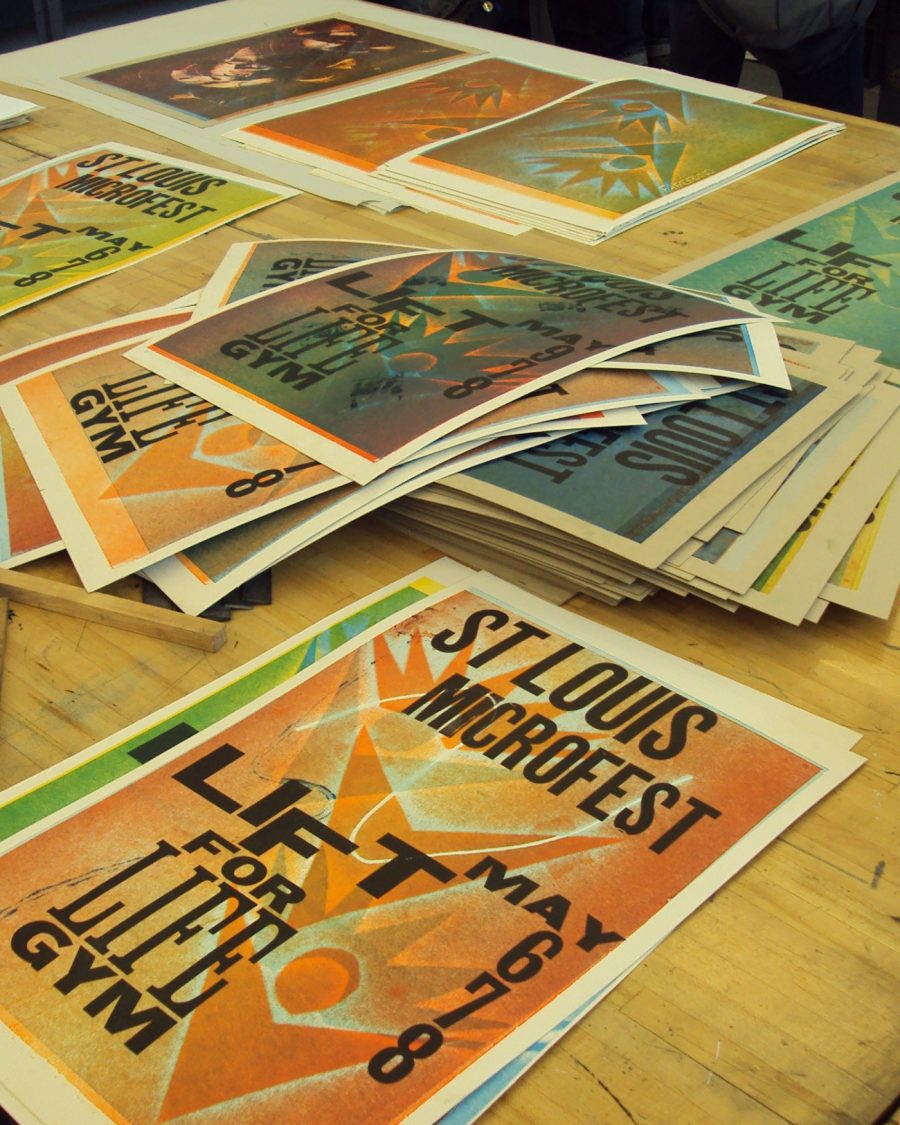 Stack of letterpress broadside prints on a print shop workbench