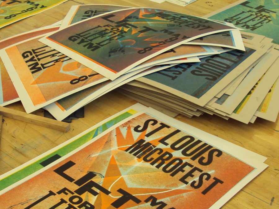 Stack of letterpress broadside prints on a print shop workbench