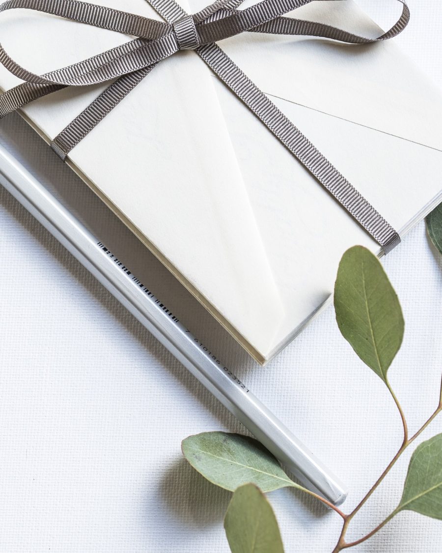 Ribbon-tied cream envelope suite with eucalyptus sprig