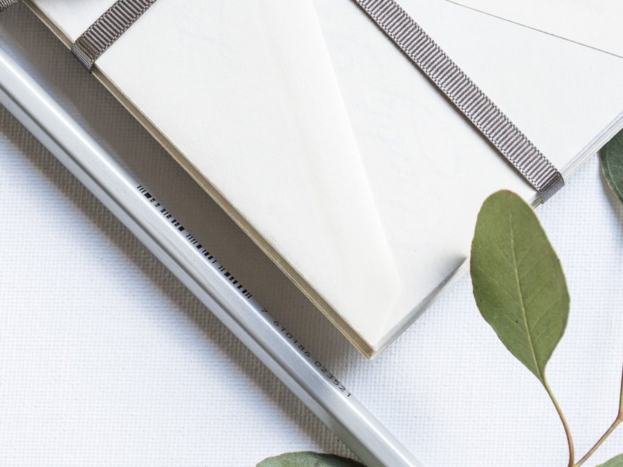 Ribbon-tied cream envelope suite with eucalyptus sprig