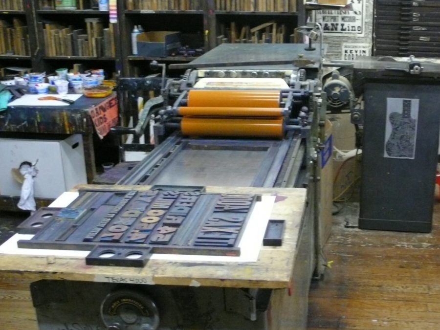 Letterpress platen press loaded with locked type, ready to print
